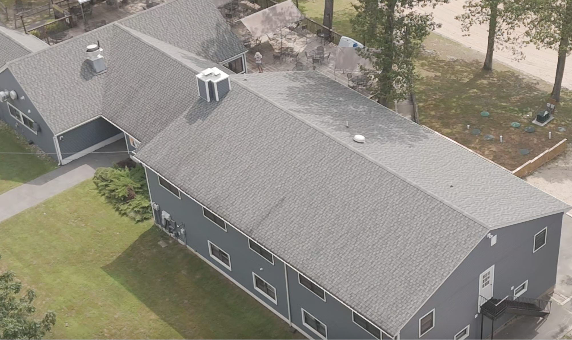 A white drone flies over a tile-covered area.